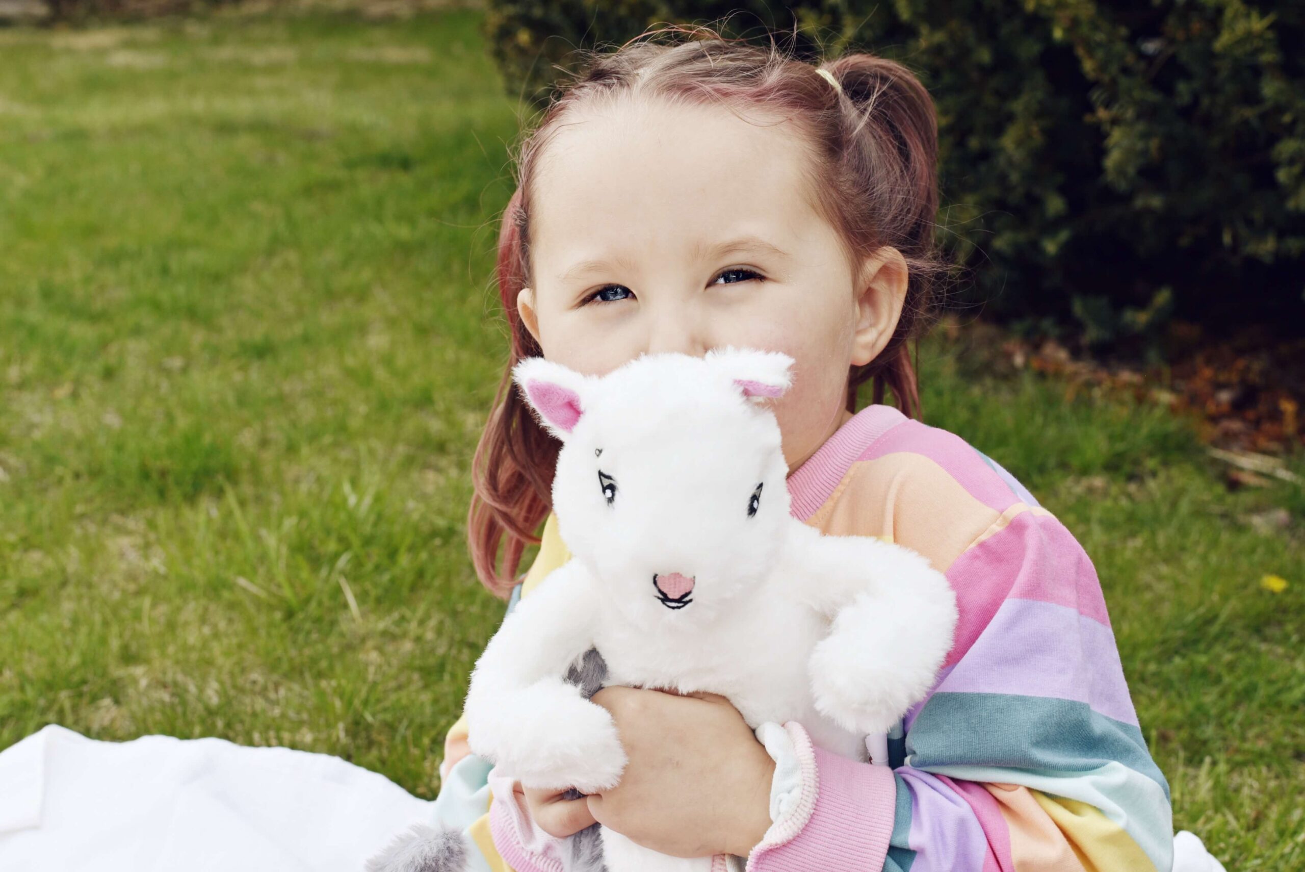 Adara kisses the stuffed Skye Squirrel