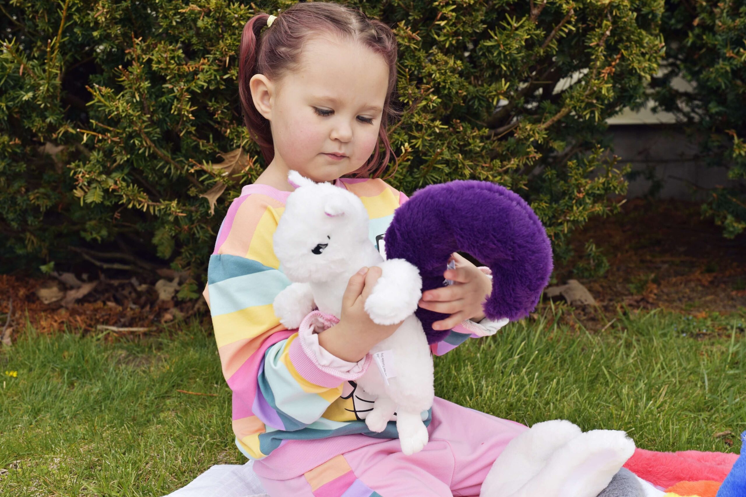 Adara attaching the purple tail to stuffed Skye Squirrel